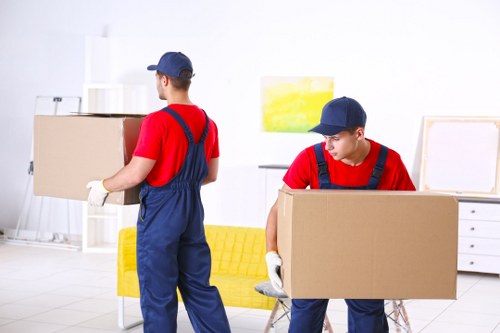 Movers preparing a safe removal with packing equipment