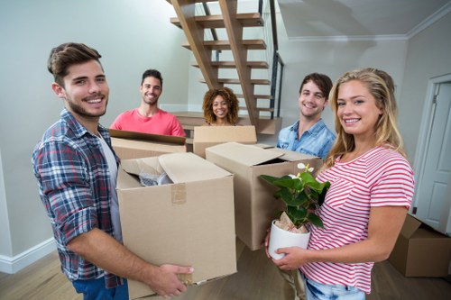 House removalists in Wimbledon loading moving boxes into a van