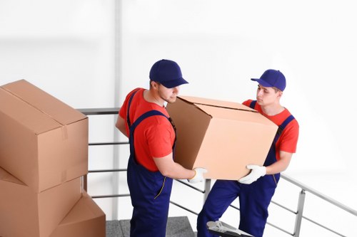 Furniture removals team handling a sofa in Wimbledon