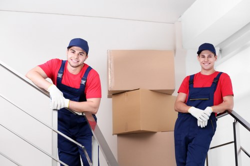 Movers sorting recyclable materials during a sustainable relocation in Wimbledon