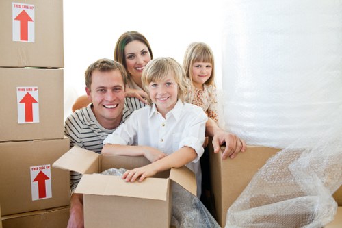 A moving crew safely transporting furniture during a Wimbledon relocation
