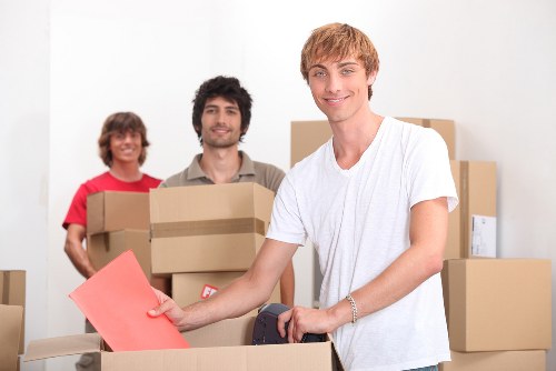 Professional movers handling office equipment during a Wimbledon relocation